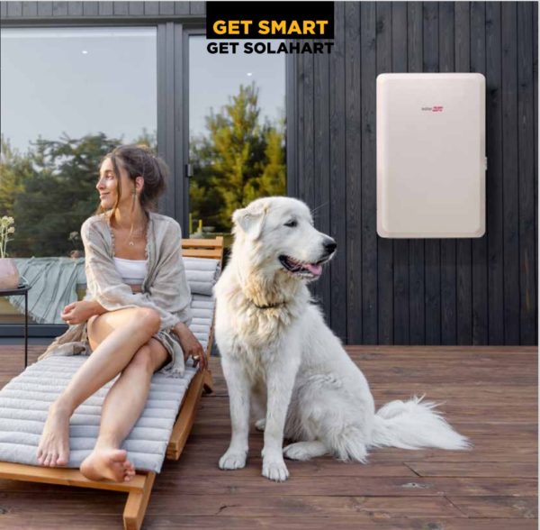 SolaEgde battery installed on the wall behind Solahart happy customers.
