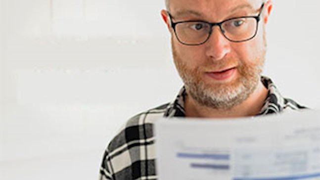 A Solahart customer looking over his energy bill.