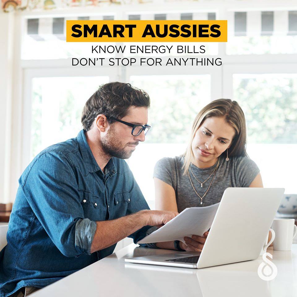 A couple looking over their energy bill knowing their energy bills don't stop for anything.